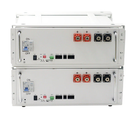 Two stacked white battery modules with terminal connections, on/off switches, communication ports, and metal side handles.